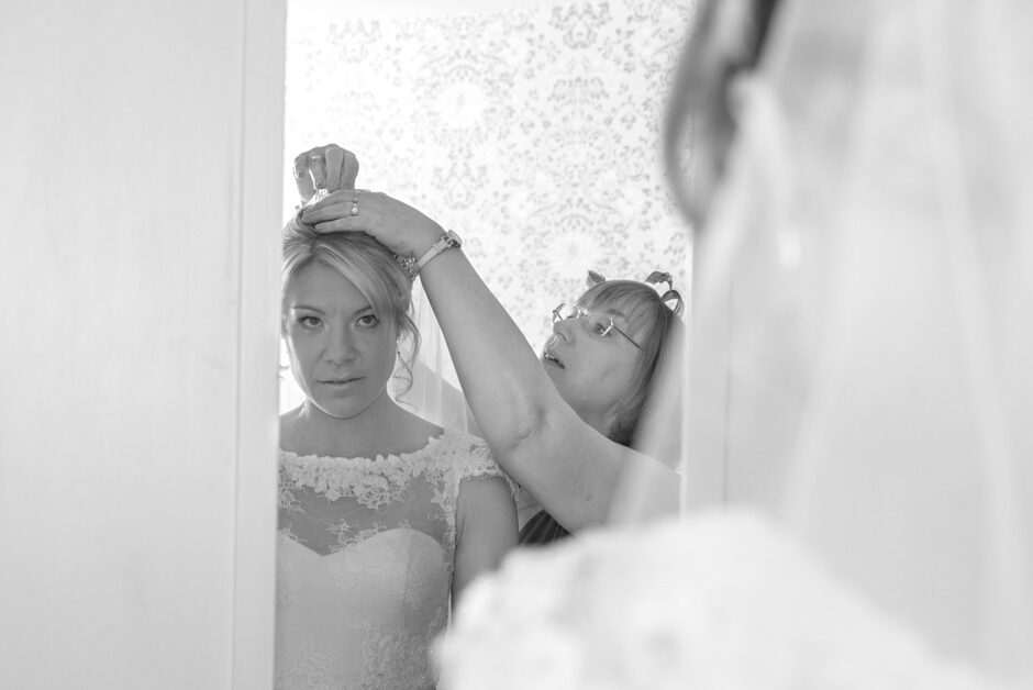 bride's mother making finishing touches to veil before wedding ceremony at Brooks Guesthouse in Bristol
