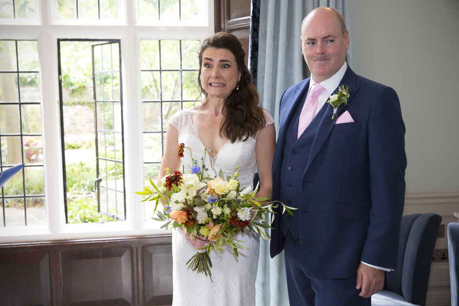 bride and groom pulling funny face when asked if anyone objects during wedding ceremony at Lewes Register Office