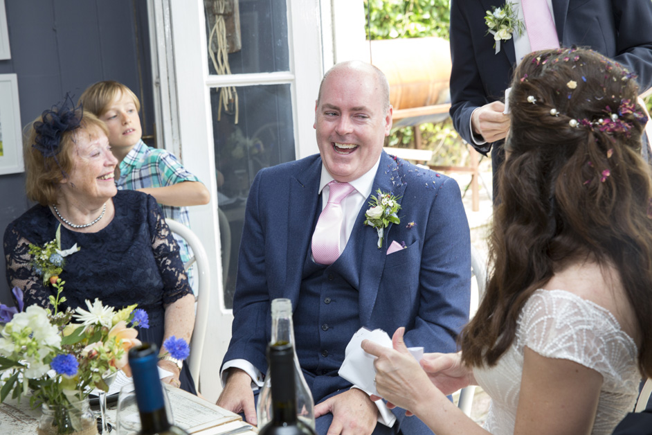groom laughs during wedding speeches at Limetree Kitchen in Lewes