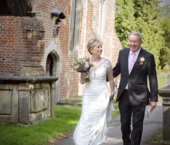 bride and groom walking into Stoke Poges Church in Reading