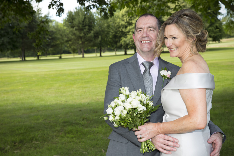 bride and groom embracing each other at their Weald of Kent wedding in Headcorn