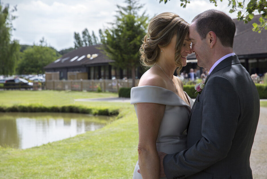 bride and groom in intimate embrace at their Weald of Kent wedding in Headcorn