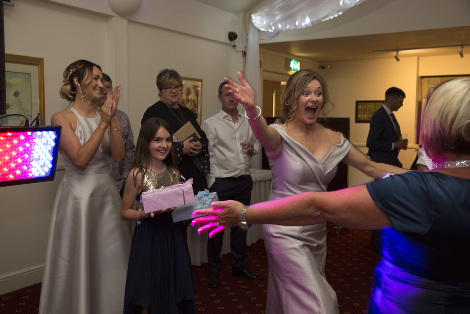 Bride very excited to greet the winner of her quiz at Weald of Kent wedding in Kent.