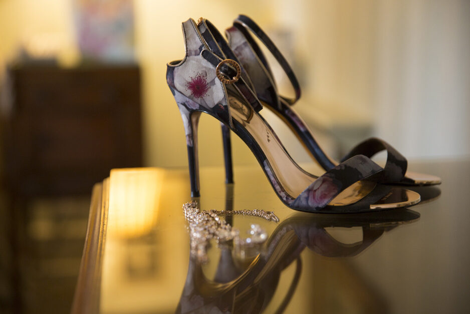 bride's wedding shoes and jewellery in bedroom at The Old Rectory at Hartwell House in Buckinghamshire