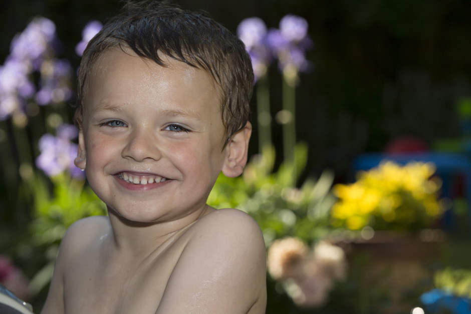 little boy smiling with wet hair in garden in Tonbridge, Kent