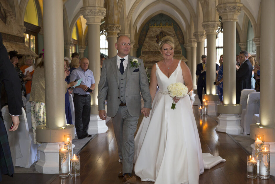 bride and groom walking up the aisle at Wotton House in Dorking, Surrey