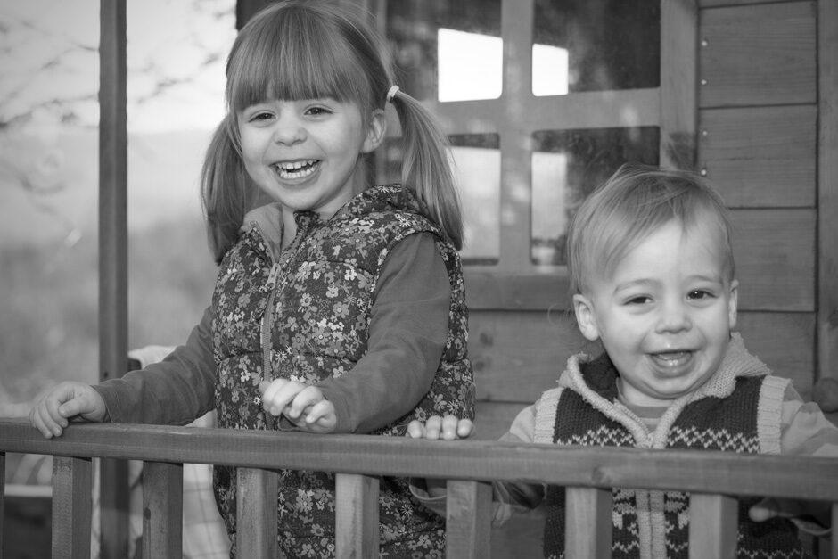 little girl and her toddler brother playing in their treehouse in Tonbridge, Kent