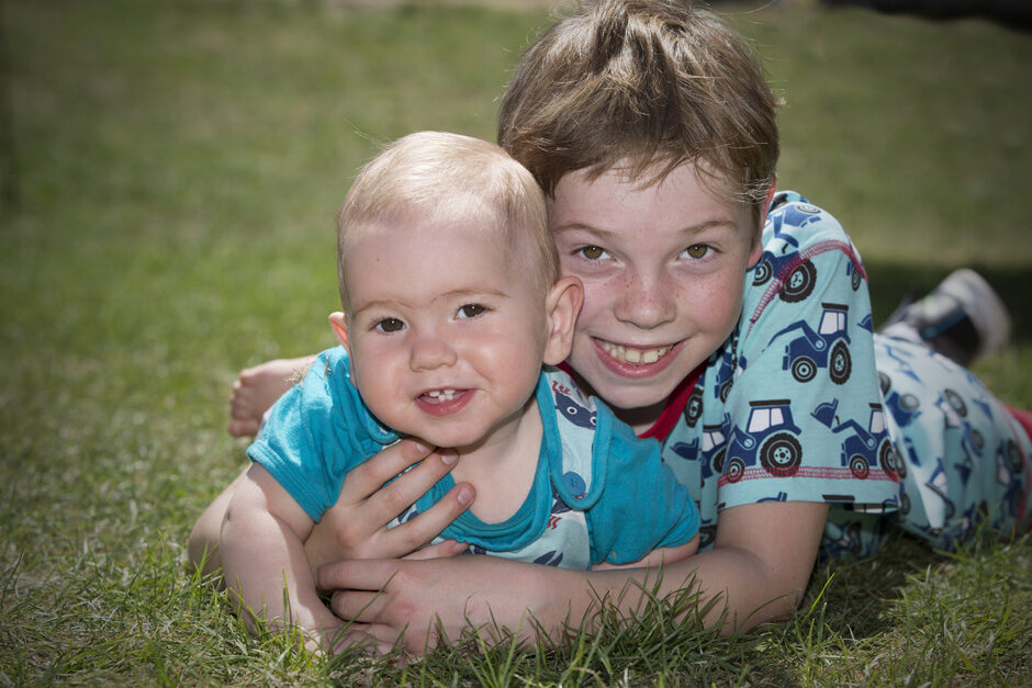 little boy with baby brother on their tummies in Tonbridge, Kent