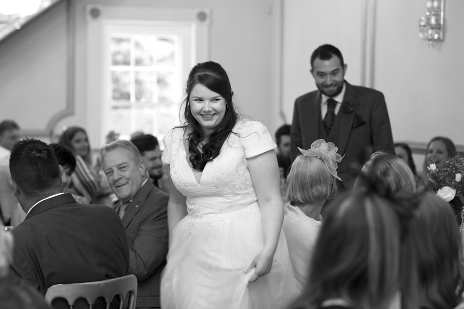 bride walking to her wedding breakfast to applause at The Little Hermitage in Rochester, Kent