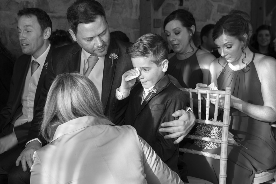 little boy best man crying with emotion during wedding ceremony at Swallows Oast at Ticehurst, East Sussex