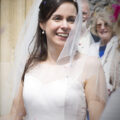 bride laughing with confetti in her hair outside Amersham Church, Bucks