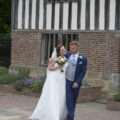 bride and groom walking outside Bridge Cottage in Uckfield