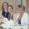 mother of the bride smiles during wedding speeches