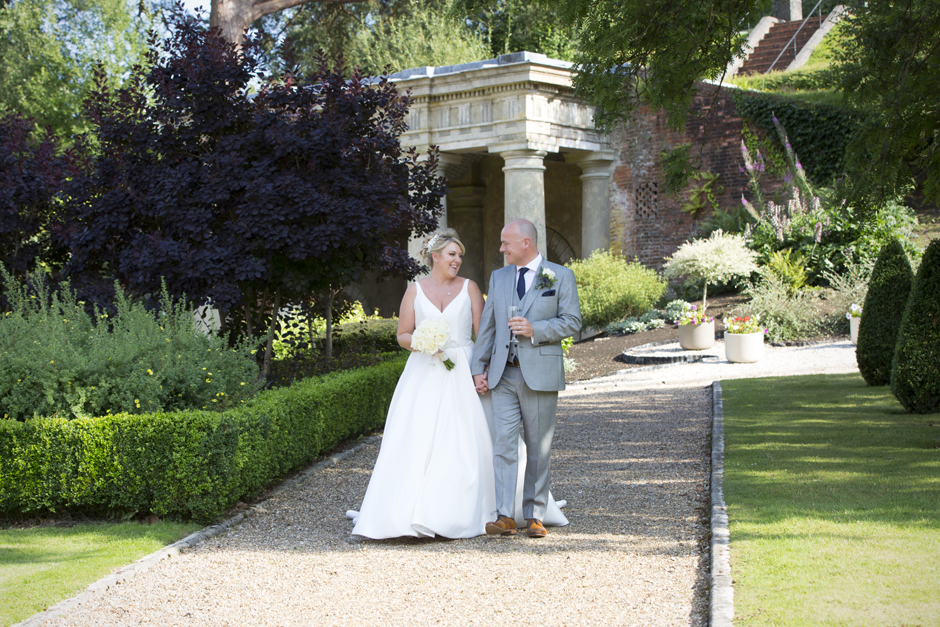 bride and groom walking outside at Wotton House in Dorking, Surrey