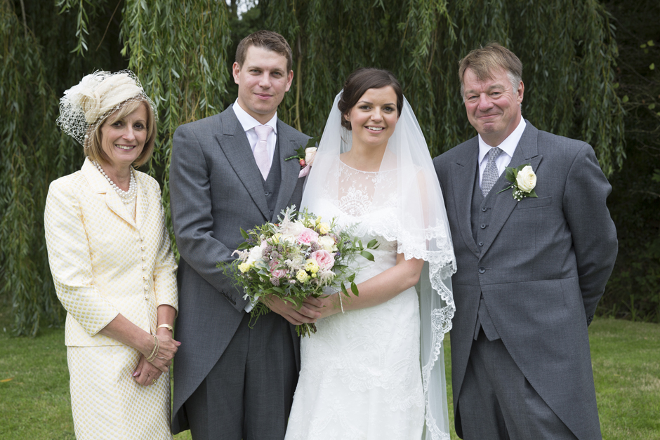 bride and groom with parents of the bride at Smarden village countryside wedding in Kent