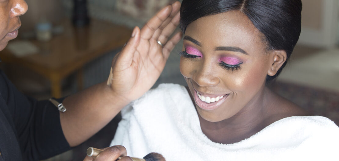 bride having blusher applied during bridal prep at The Old Rectory at Hartwell House in Buckinghamshire. Captured by Kent wedding photographer Victoria Green.