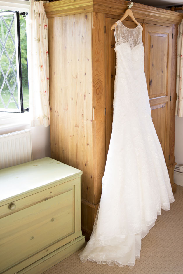 bride's dress hanging on the wardrobe in her bedroom at her Smarden house in Kent