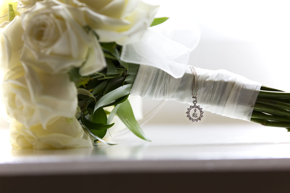 Bride's necklace captured on bouquet at Wotton House, Dorking in Surrey