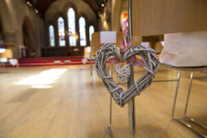Wooden heart chair decoration at St Stephen's Church wedding in Tonbridge, Kent.