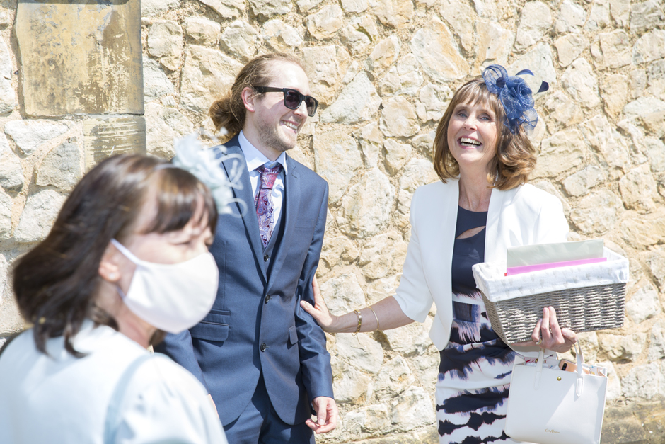 Mother of the bride laughing with guests at St Stephen's Church wedding in Tonbridge, Kent