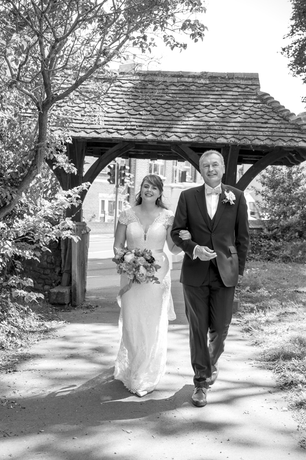 Bride and Bride's Father walking down the church pathway to St Stephen Church, Tonbridge in Kent