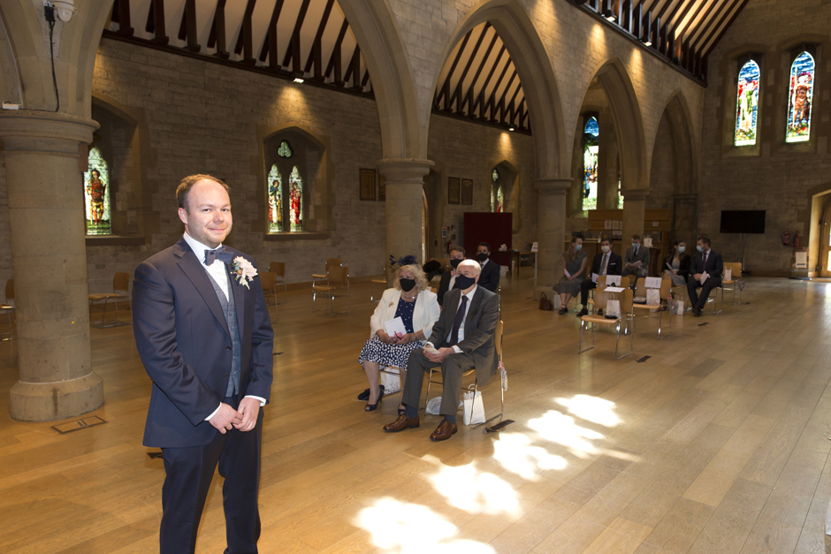 Groom waiting for bride with guests at St Stephen's Church in Tonbridge, Kent