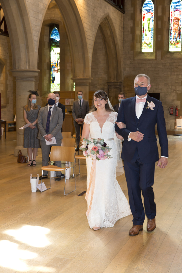 Bride and Father smiling walking down the aisle at St Stephen's Church wedding in Tonbridge, Kent