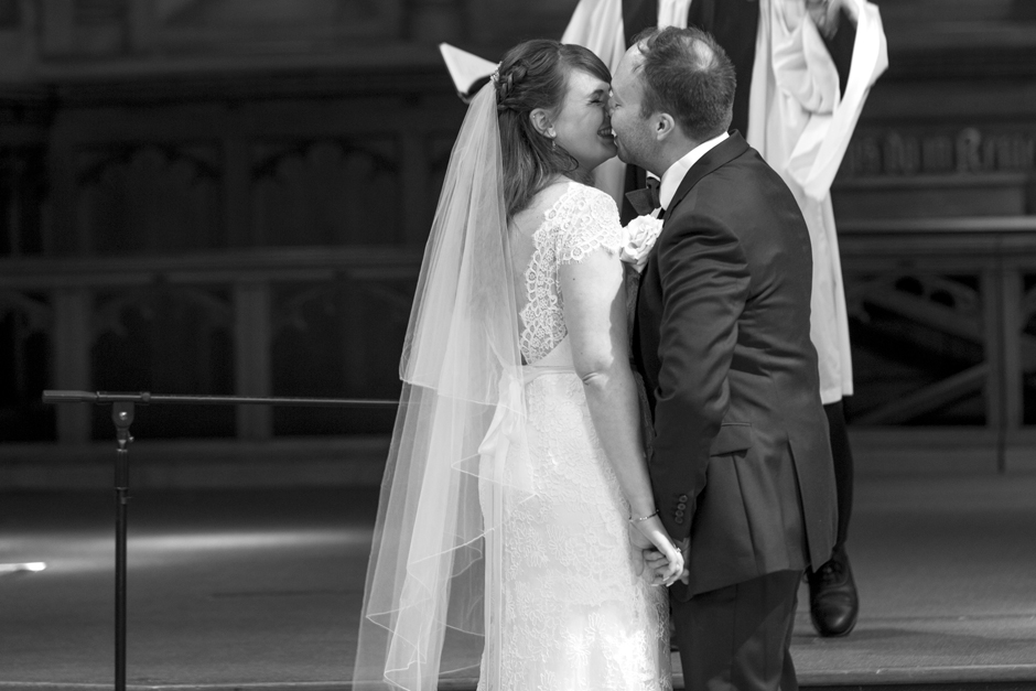 Bride and Groom kiss during St Stephen's church wedding ceremony in Tonbridge, Kent