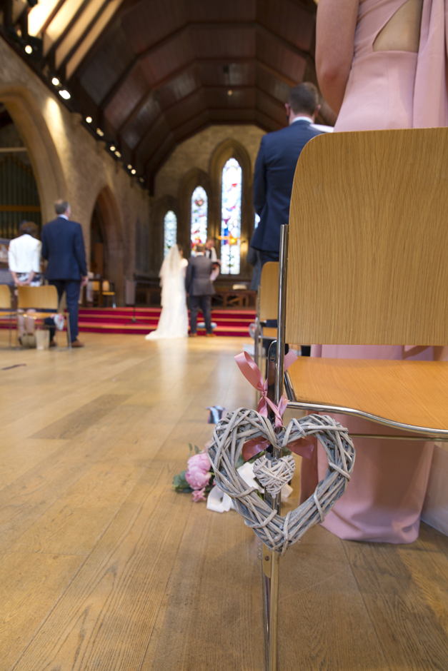 Woven Wooden chair decoration at wedding ceremony at St Stephen's Church in Tonbridge, Kent