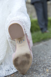 Bride's engraved new surname initial on back of shoe at Tonbridge wedding in Kent