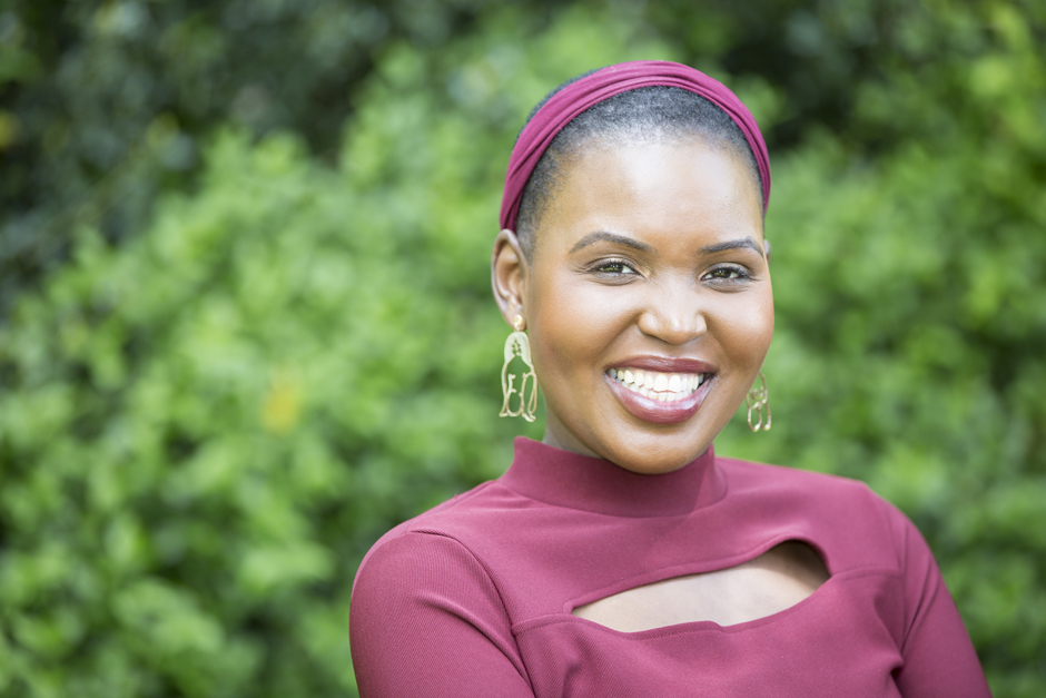 Black woman in maroon outfit laughing outside captured by Kent photographer Victoria Green