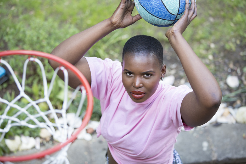 Black woman holding basketball ready to shoot in the hoop captured by Kent photographer Victoria Green
