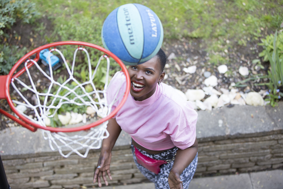 Black woman throwing a basketball in the hoop captured by Kent photographer Victoria Green