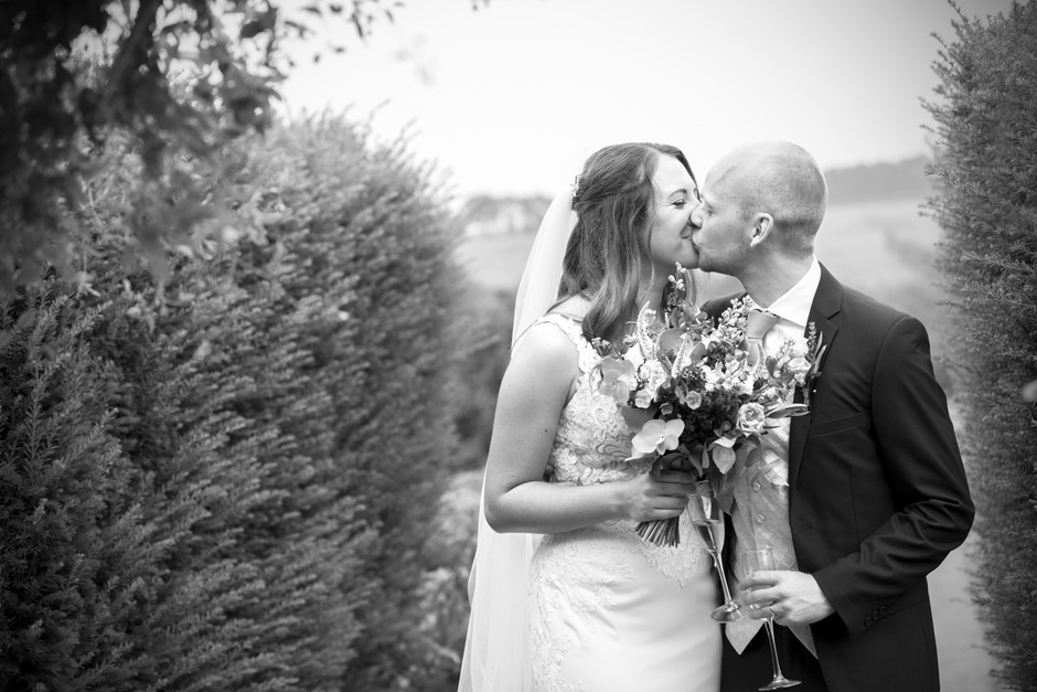 Bride and groom sharing an intimate kiss at Nettlestead Place wedding. Captured by Victoria Green Photography.