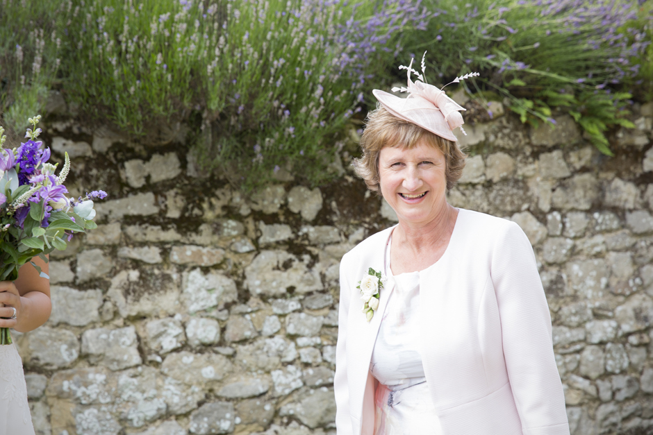 Bride's mother laughing at Nettlestead Place wedding in Kent.