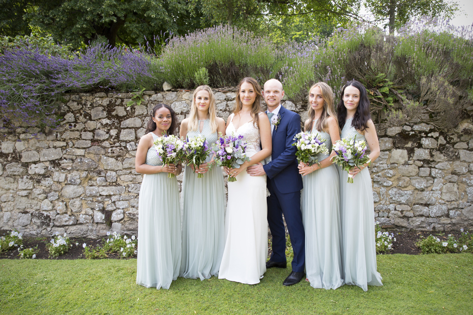 Bride and groom with bridesmaids at Nettlestead Place wedding, Maidstone in Kent.