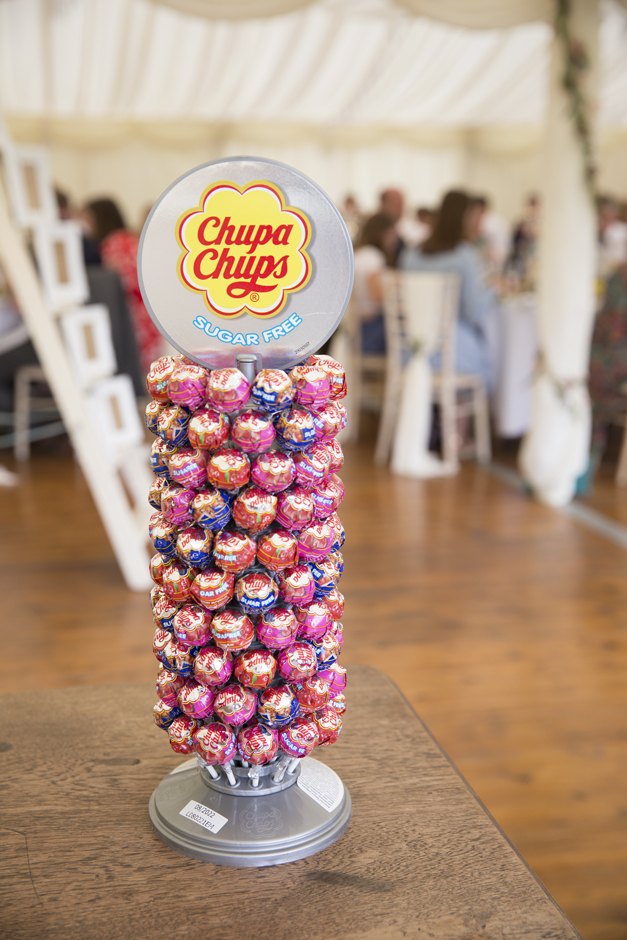 Chuppa chups stand on wedding table at Nettlestead Place, Maidstone in Kent.