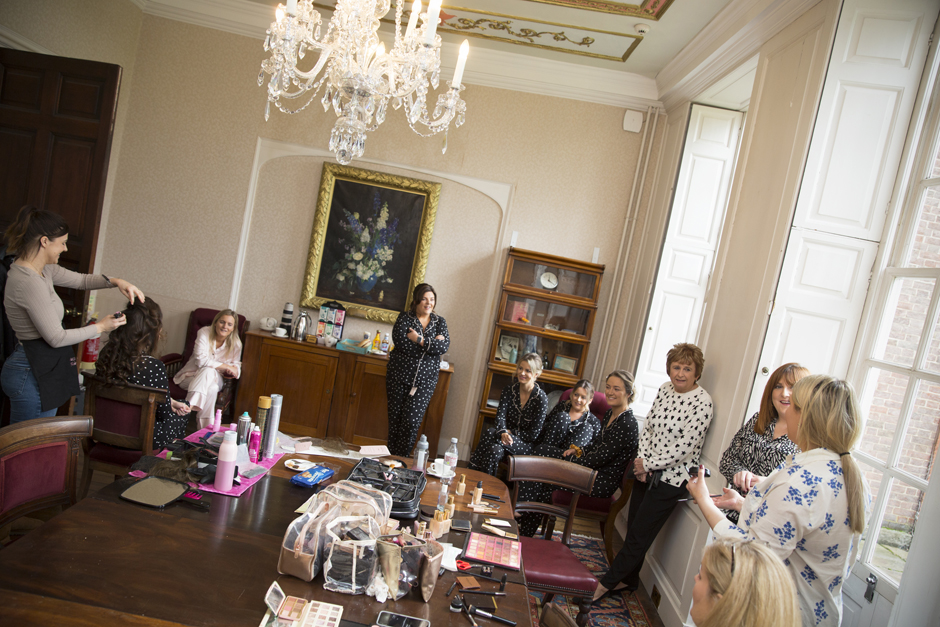 Wide shot of bridesmaids chatting and getting ready during morning bridal prep at Bradbourne House, East Malling in Kent.