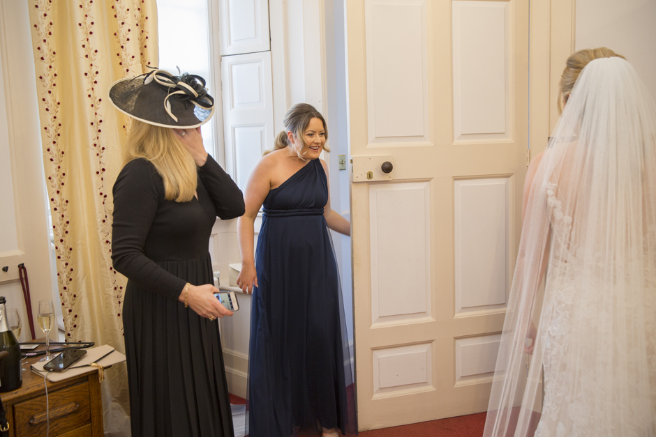 Chief bridesmaid getting a first glance of the bride at Bradbourne House wedding in East Malling, Kent.