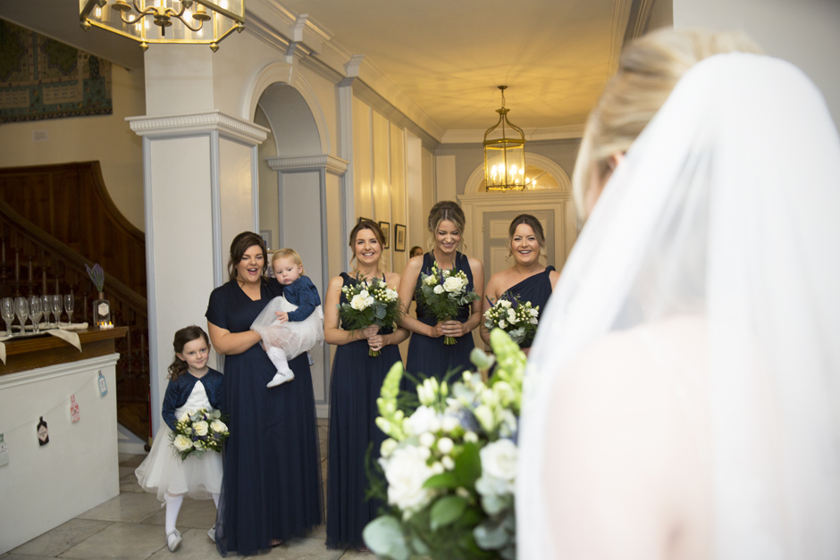 Bride reveal to smiling bridesmaids at Bradbourne House wedding in East Malling, Kent.