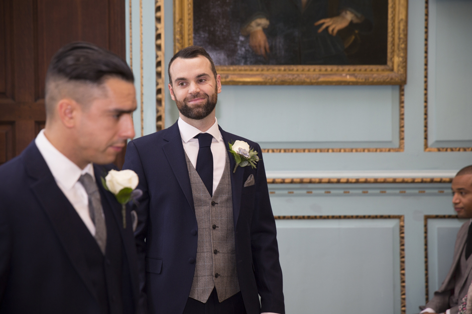Groom looking nervous before the wedding ceremony at Bradbourne House in East Malling, Kent.