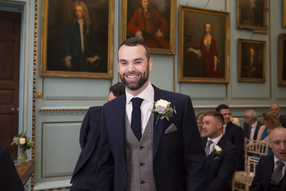 Groom smiling before the wedding ceremony at Bradbourne House, East Malling in Kent.