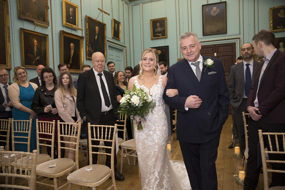 Bride and Bride's Dad walking down the aisle during the inside wedding ceremony at Bradbourne House in East Malling, Kent.