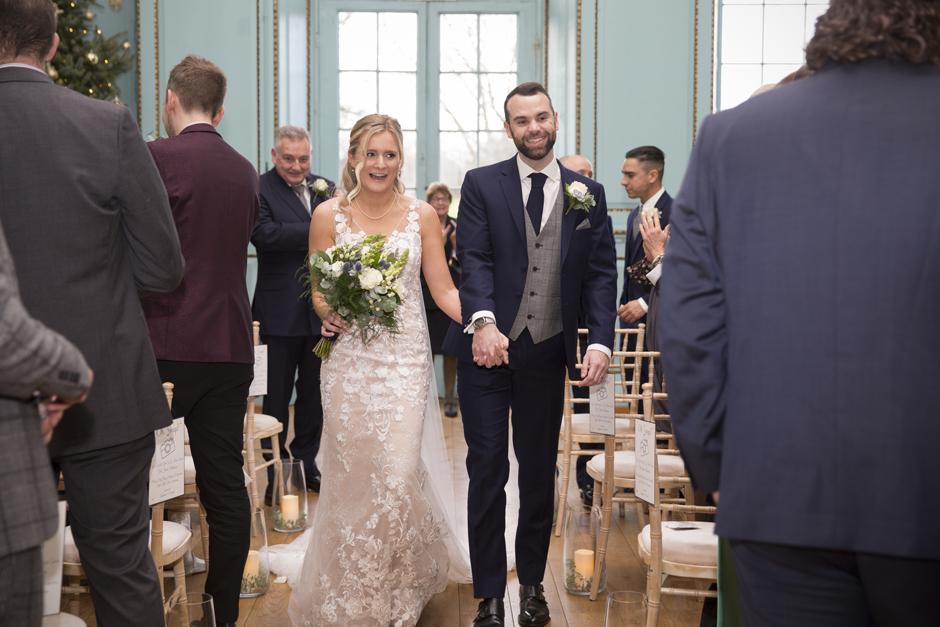 Bride & Groom laughing walking up the aisle during wedding ceremony at Bradbourne House in East Malling, Kent.