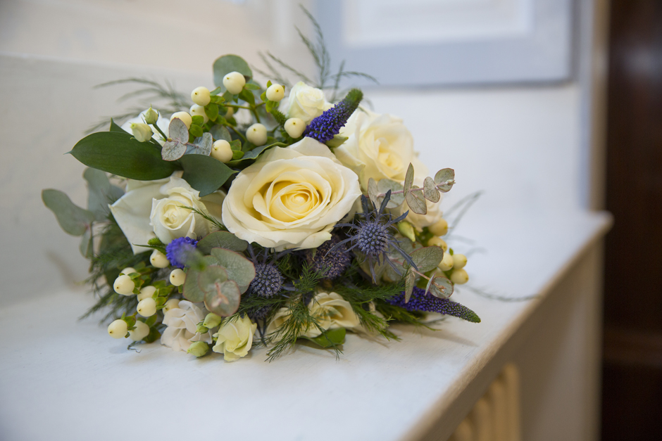 Close-up of Bride's bouquet - yellow roses and purple thistle - at Bradbourne House in East Malling, Kent.