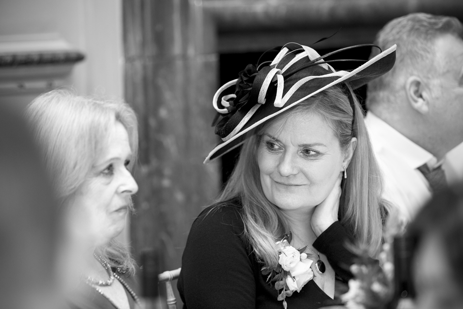 Bride's Mother listening thoughtfully during wedding breakfast at Bradbourne House in East Malling, Kent.