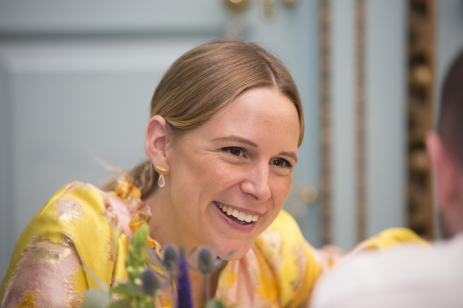 Female wedding guest laughing during wedding breakfast at Bradbourne House, East Malling in Kent.