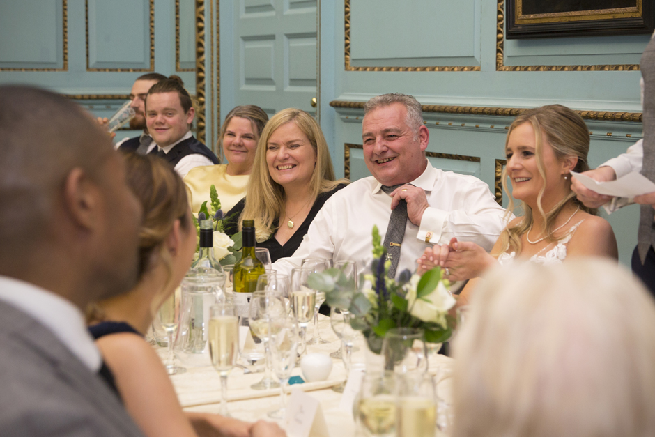 Top table laughing during the wedding speeches at Bradbourne House in East Malling, Kent.
