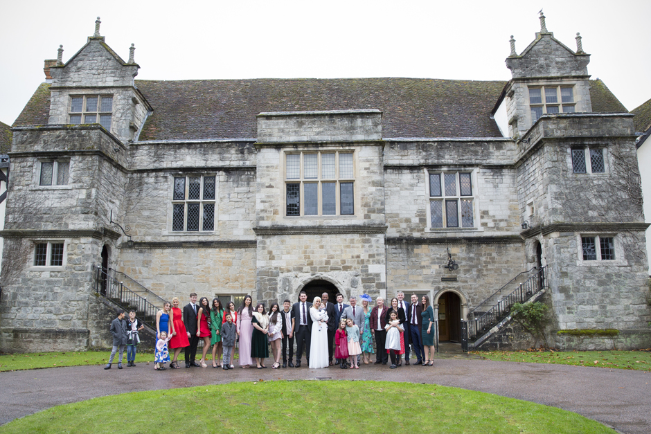 Wedding guests outside Archbishop's Palace Register Office in Maidstone, Kent. Captured by Victoria Green Photography.