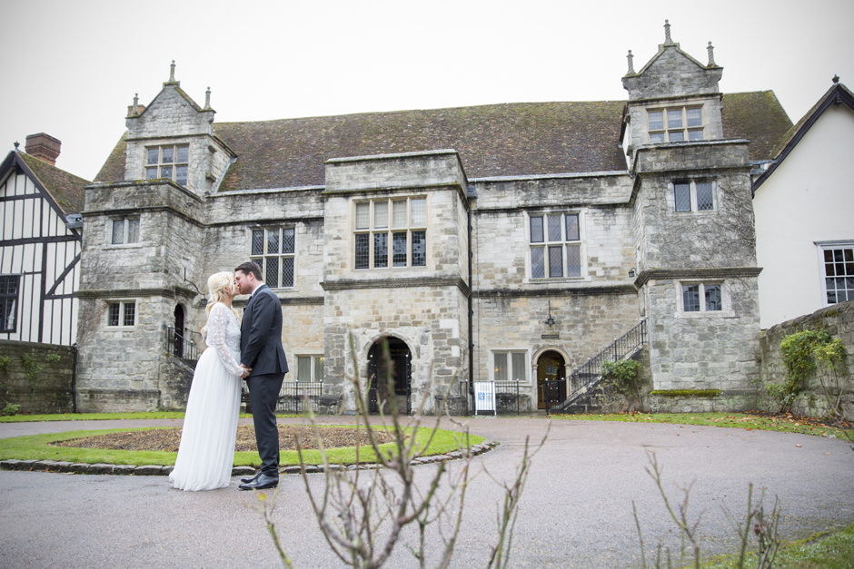 Bride and Groom kissing in front of Archbishop's Palace Register Office in Maidstone, Kent. Captured by Victoria Green Photography.